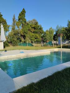 a swimming pool with blue water in a yard at Quinta don josé in Luján