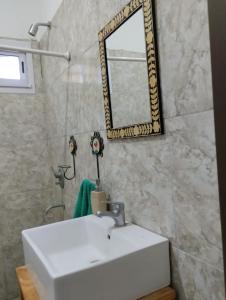 a bathroom with a white sink and a mirror at Quinta don josé in Luján