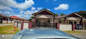 a car parked in front of a house at Serai Homestay in Dungun