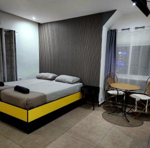 a bedroom with a bed and a table and chairs at Amdar boutique in Eilat