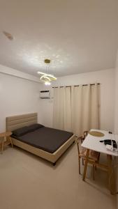 a bedroom with a large bed and a table at Minimalist Retreat in Minglanilla