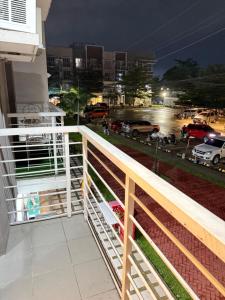 a balcony with a view of a parking lot at night at Minimalist Retreat in Minglanilla
