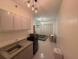 a kitchen with a sink and a bed in a room at Minimalist Retreat in Minglanilla