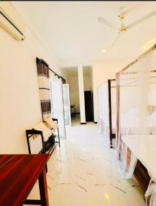 a living room with a couch and a table at Surf Bay Hotel in Arugam Bay +17 photos