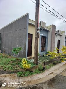a house on the side of a street at Lover's Nest Guest House in Bangad