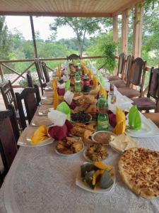 a long table with plates of food on it at Riverside Nature in Martvili