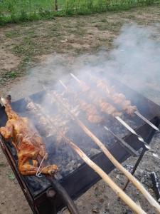 a bunch of meat cooking on a grill at Riverside Nature in Martvili