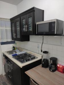 a kitchen with a stove and a microwave at Cozy Apartamento en Puebla! in San Baltasar +19 photos