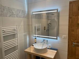 a bathroom with a sink and a mirror at Chalets Coeur du Lac in Malbuisson +62 photos