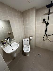 a bathroom with a toilet and a sink at The Regency PortDickson A1-7 in Port Dickson +24 photos