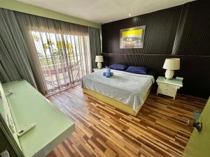 a bedroom with a bed and a large window at The Regency PortDickson A1-7 in Port Dickson