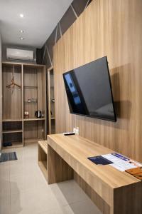 a flat screen tv on the wall of a room at Grand Kuta Hotel Lombok - Pool - 43 inch Google TV - Strong 60Mbps WiFi - New Enhanced Management in Kuta Lombok