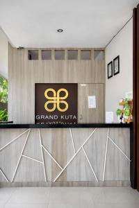 a grand nirvana hotel lobby with a sign on the counter at Grand Kuta Hotel Lombok - Pool - 43 inch Google TV - Strong 60Mbps WiFi - New Enhanced Management in Kuta Lombok +21 photos