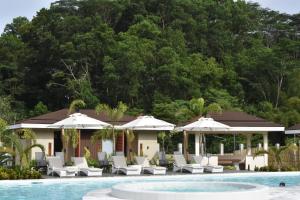 a resort with a pool and chairs and umbrellas at Kenjelo Farm and Recreation Resort in Dullan