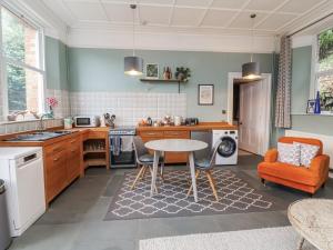 a kitchen with a table and chairs in a room at Ferndale in Lynton