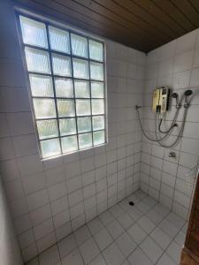 a bathroom with a shower and a window at Little Bro Mae Hong Son in Ban Mai