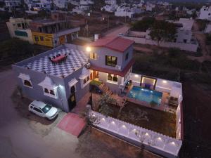 a house with a car parked in front of it at The Gold Mount Villa in Udaipur