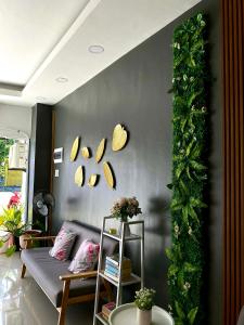 a living room with a couch and a green wall at Lagkaw Ekonotel in Dipolog +2 photos