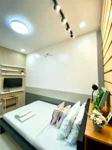 a bedroom with a bed with white sheets and pillows at Lagkaw Ekonotel in Dipolog