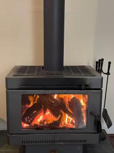 a stove with a fire inside of it at Banana Pancakes in Margaret River Town +8 photos