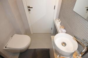 a bathroom with a white toilet and a sink at Dar22 in Fad‘ūs +6 photos