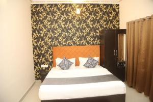 a bedroom with a bed with a black and gold wallpaper at The Gold Mount Villa in Udaipur