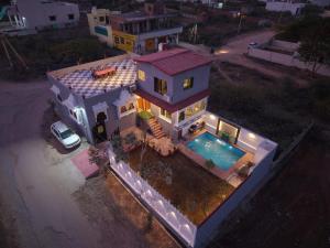 an overhead view of a house with a swimming pool at The Gold Mount Villa in Udaipur