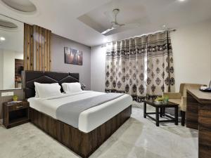 a bedroom with a large bed and a desk at Hotel Delhi Aerocity in New Delhi +52 photos