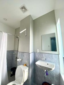 a bathroom with a toilet and a sink at Lagkaw Ekonotel in Dipolog
