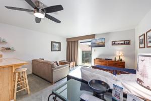 a living room with a couch and a ceiling fan at Cozy Studio w/ Partial Lake view #223 at Donner Lake Village in Truckee +5 photos