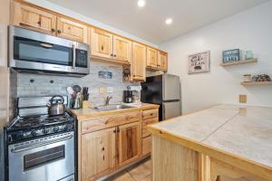 a kitchen with wooden cabinets and a stainless steel appliances at Cozy Studio w/ Partial Lake view #223 at Donner Lake Village in Truckee