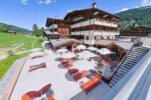 an aerial view of a building with tables and umbrellas at La Clef des Champs in Morzine