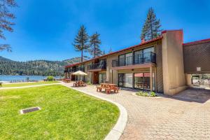 an exterior view of a building with a lawn and tables at Cozy Studio w/ Partial Lake view #223 at Donner Lake Village in Truckee
