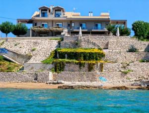a house on the shore of the water at Dip in the blue - 2 in Agios Georgios