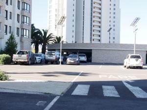 a parking lot with cars parked in front of buildings at Departamento La Serena in Coquimbo