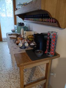 a counter with a table with food and drinks on it at Casa Agricola Amicizia in Poiana Maggiore