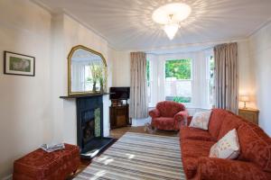 a living room with a couch and a fireplace at Lamb's Knees in Seaford