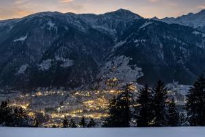 a view of a city in the mountains with snow at Echor Himalayan Sky Cabins Sethan, Manali in Manāli +32 photos
