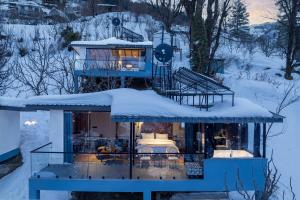 a house covered in snow with a roof at Echor Himalayan Sky Cabins Sethan, Manali in Manāli