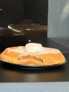 a piece of cake on a plate with whipped cream at Mountain View Home in Zalău