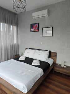 a bedroom with a large bed with white sheets at Maximos Luxury Villa Monagri Limassol in Monagri +11 photos