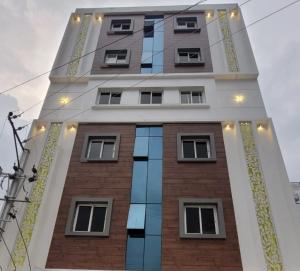a tall building with windows and lights on it at Hotel La Hotera in Hyderabad