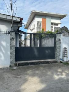 a black gate in front of a house at Casa Residence by Baluyut in Concepcion