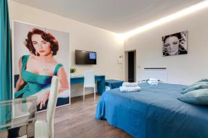 a room with a bed and a large painting of a woman at Dolce Vita Suite in Florence