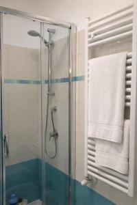 a bathroom with a glass shower with a towel at Appartamento L'Olivo in Latina +26 photos