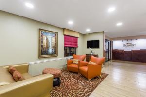 a hotel lobby with couches and a waiting room at Baymont by Wyndham Savannah/Garden City in Savannah