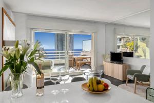 a living room with a table with a bowl of fruit at Beausoleil near Monaco - Cosy Studio with Sea view in Beausoleil +30 photos