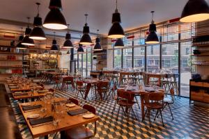 
a restaurant with tables, chairs, and tables in it at Arlo SoHo in New York
