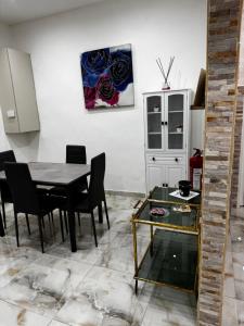 a dining room with a table and black chairs at Casa Rosa in Monterotondo
