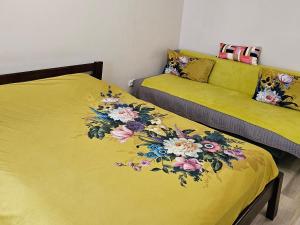 a bedroom with two beds with flowers on them at Квартира-студія центр Огієнка 2а in Lutsk